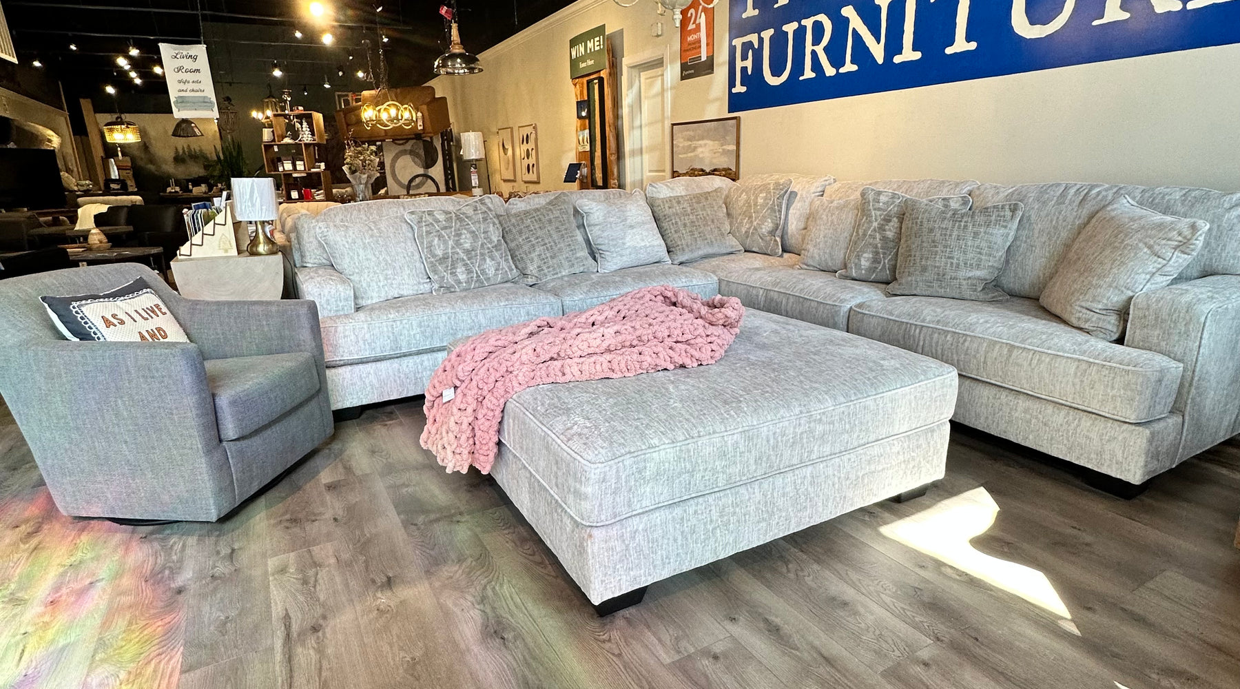 sofa and chair inside tru furniture under tru furniture sign 
